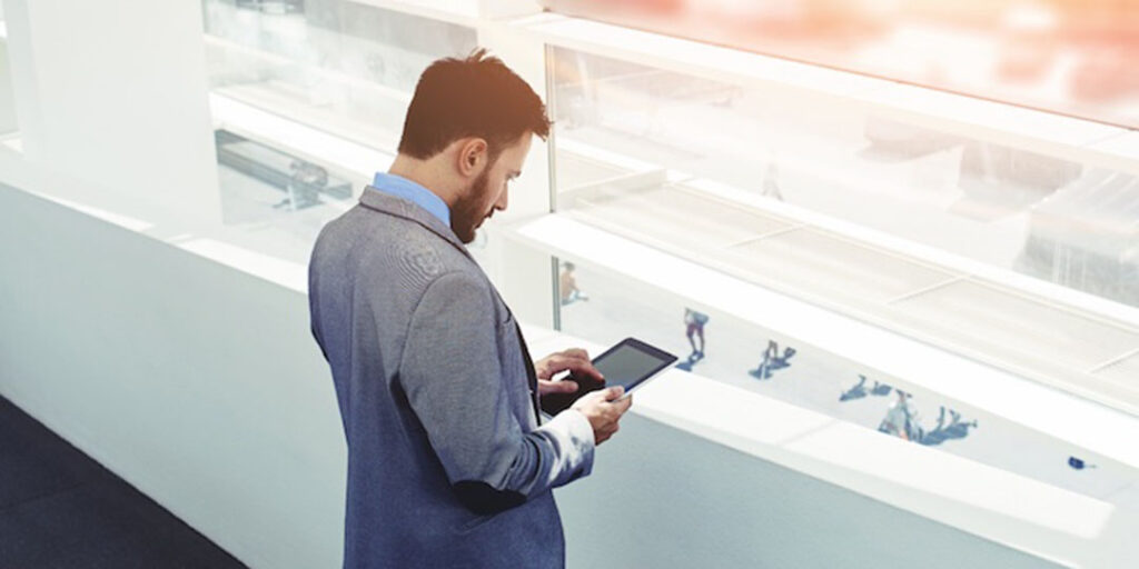 A businessman holding a tablet