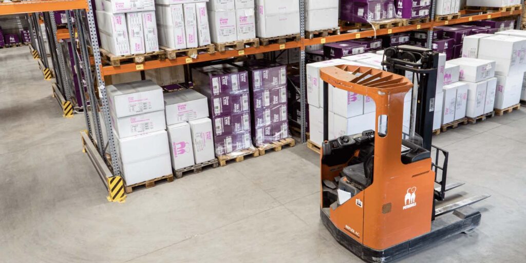 Forklift in warehouse unloading inventory